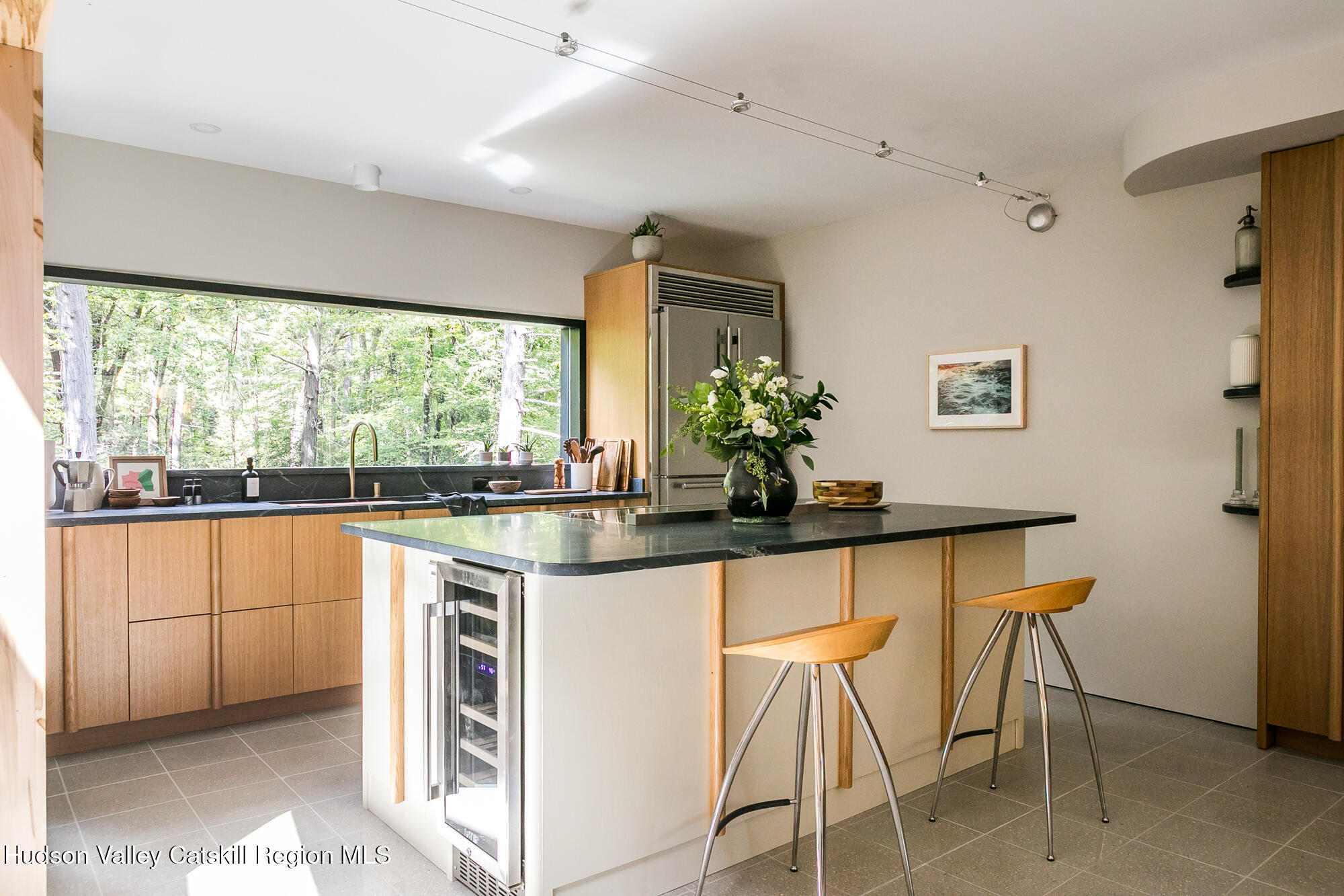 35 Fern Hollow Road Stone Ridge, NY 12484 - Photo 12 of 40 a kitchen with stainless steel appliances granite countertop a table and chairs in it