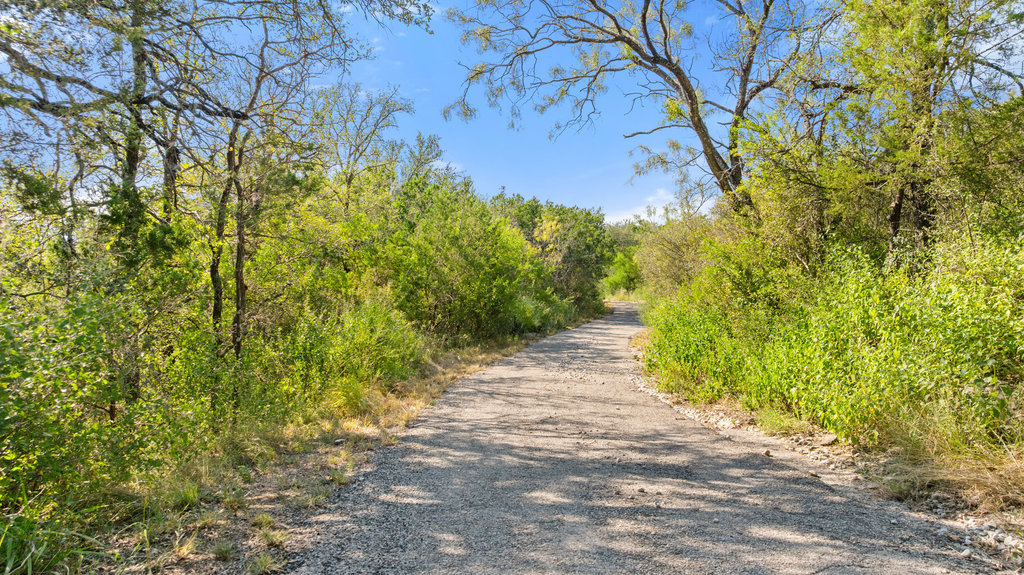 111 Swift Water Road Marble Falls, TX 78654 - Photo 6 of 37 a view of a pathway both side of yard