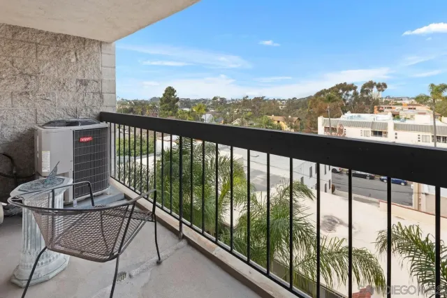 a view of a balcony with furniture