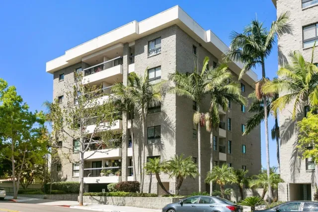 a front view of a building with a garden
