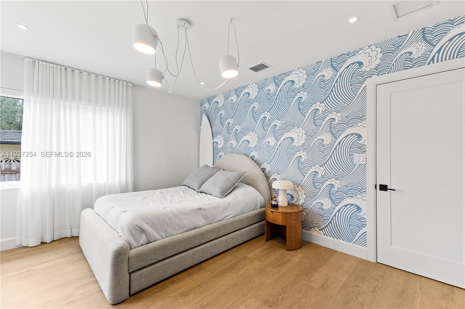 800 Northeast 72nd Street Miami, FL 33138 - Photo 17 of 48 a bedroom with a bed and a window