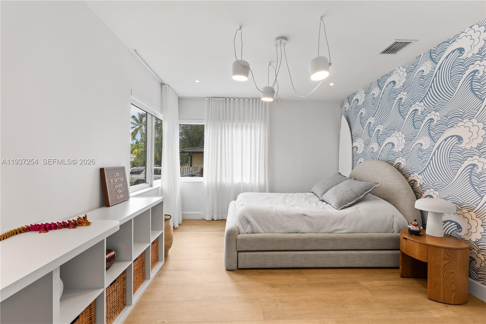 800 Northeast 72nd Street Miami, FL 33138 - Photo 19 of 48 a spacious bedroom with a bed and a chandelier