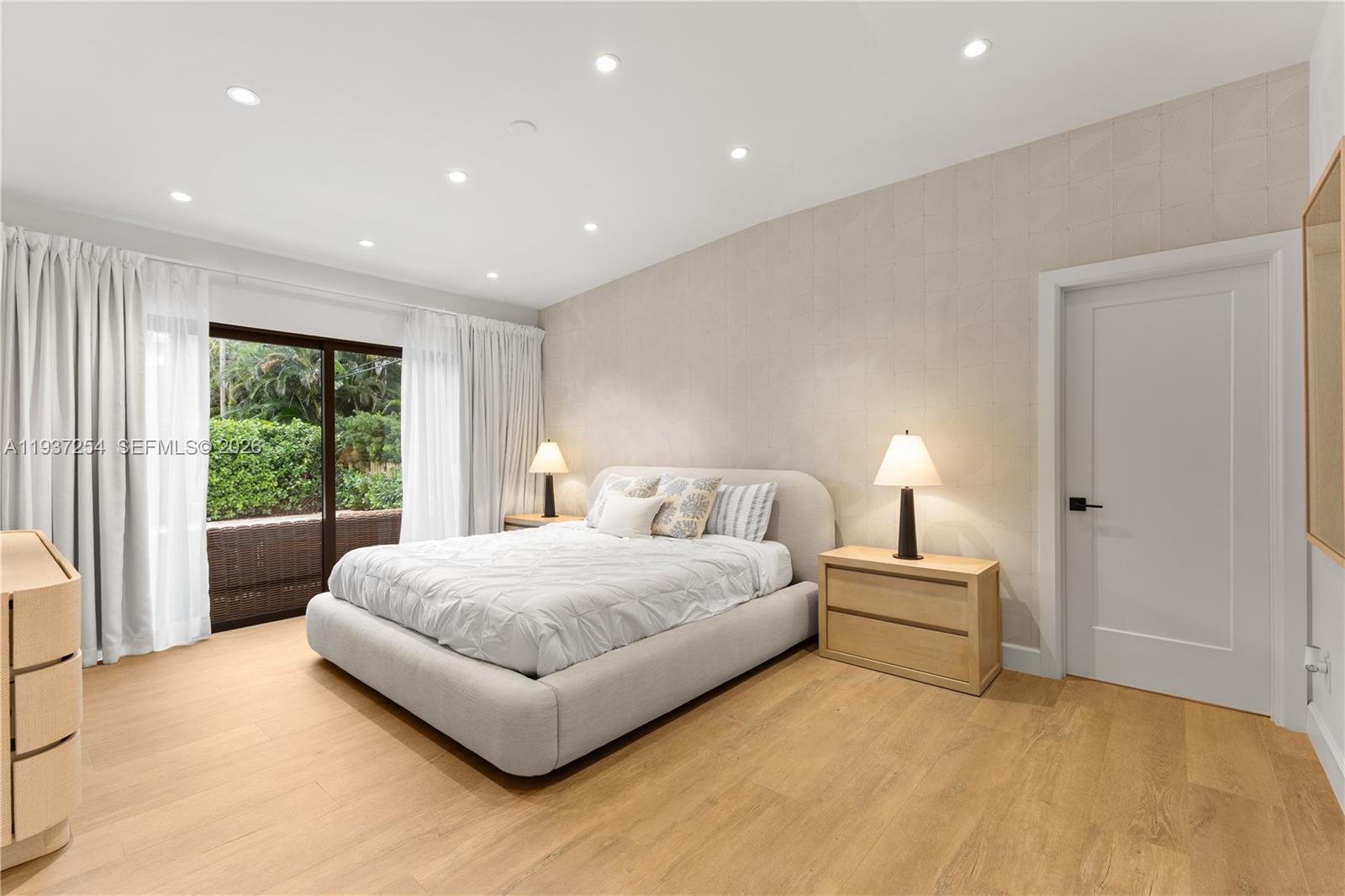 800 Northeast 72nd Street Miami, FL 33138 - Photo 27 of 48 a spacious bedroom with a large bed and a large window