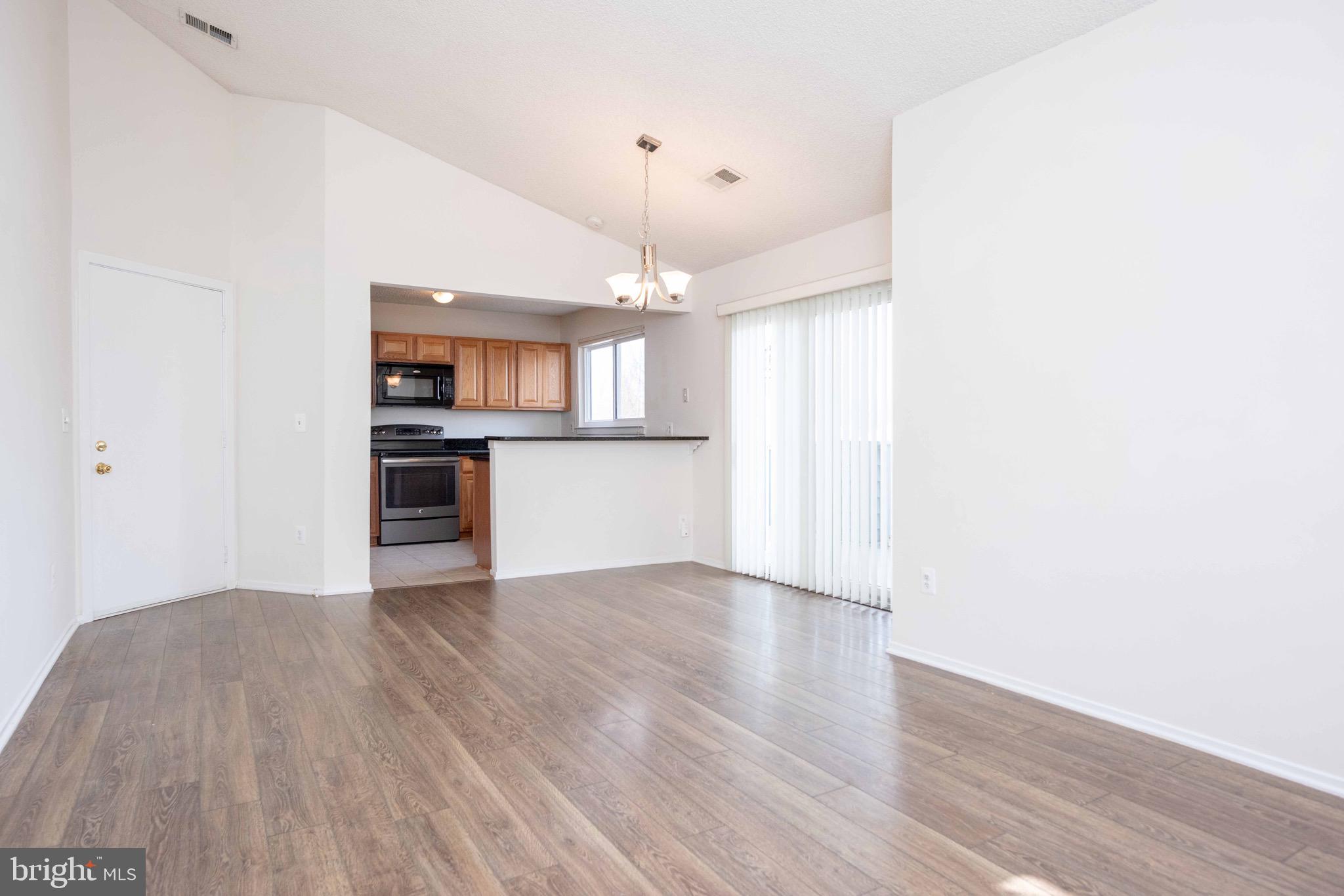 11708 Summerchase Circle, Unit 1708E Reston, VA 20194 - Photo 3 of 17 a view of a kitchen with a sink cabinets and wooden floor