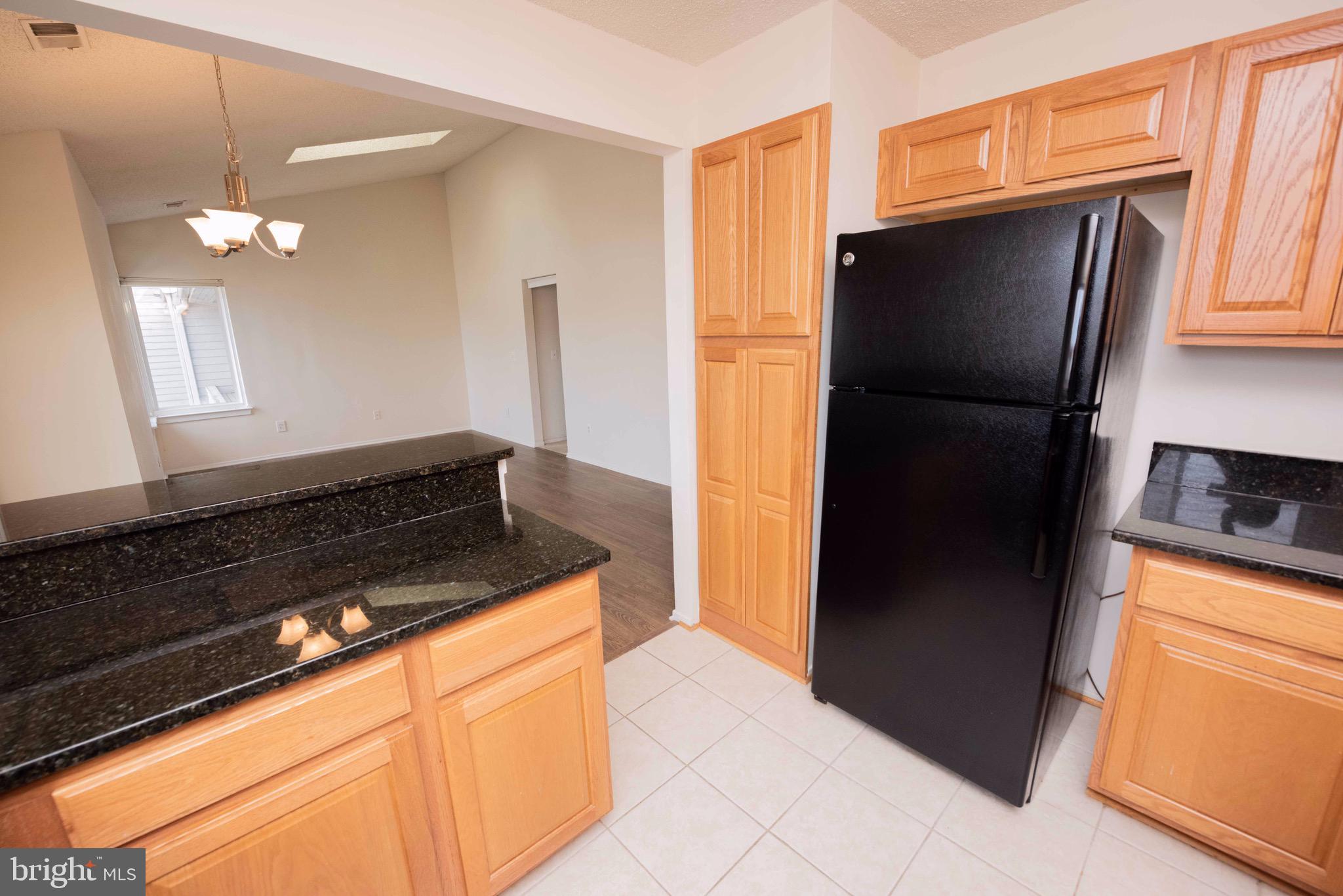 11708 Summerchase Circle, Unit 1708E Reston, VA 20194 - Photo 7 of 17 a kitchen with stainless steel appliances granite countertop a refrigerator and a sink