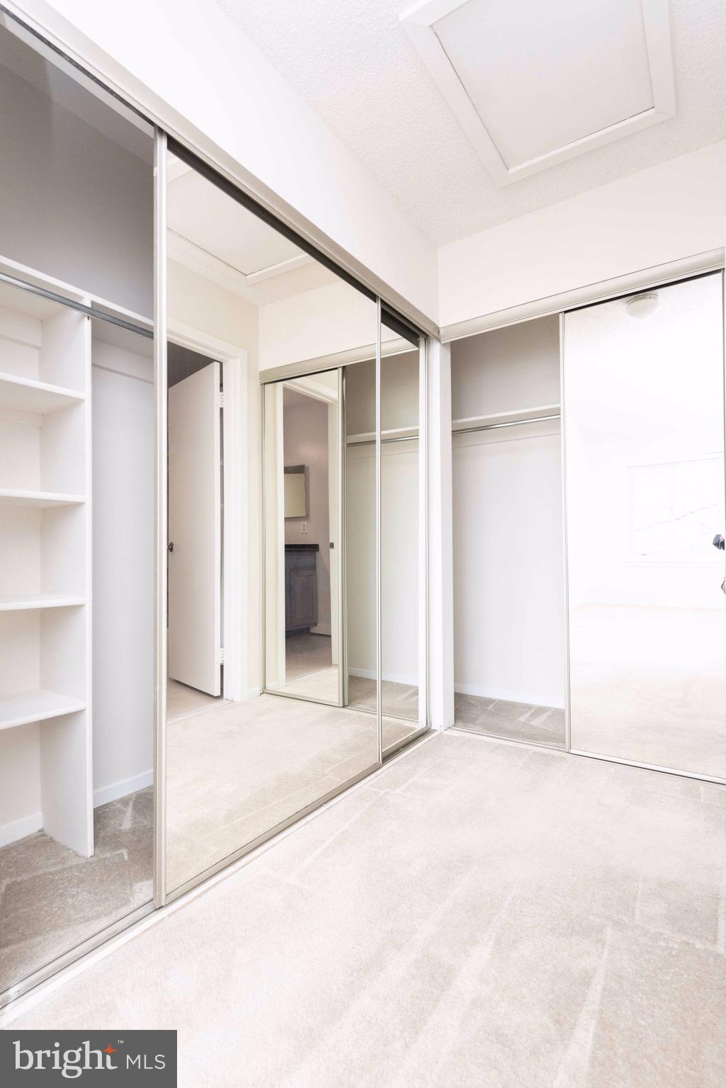 11708 Summerchase Circle, Unit 1708E Reston, VA 20194 - Photo 10 of 17 an empty room with closet and windows