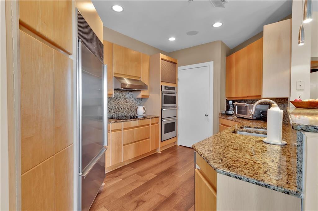 2828 Peachtree Road Northwest, Unit 1402 Atlanta, GA 30305 - Photo 17 of 23 a kitchen with stainless steel appliances granite countertop a sink and cabinets