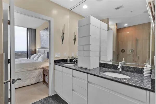 a bathroom with double vanity sinks and a mirror