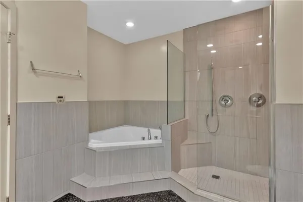 a bathroom with a shower a toilet and a shower