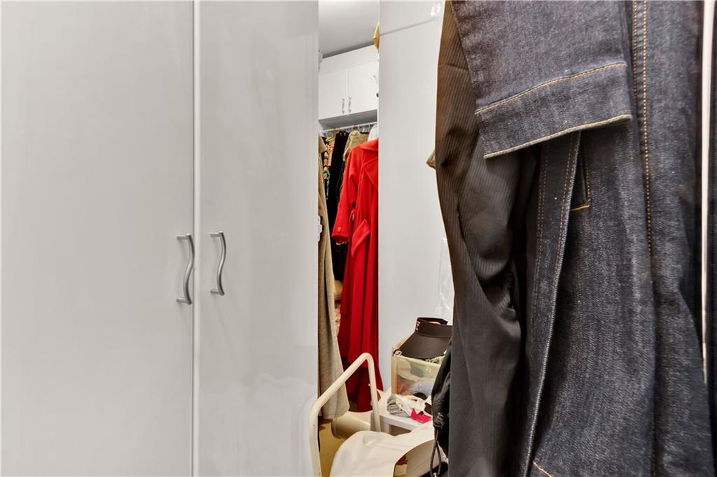 2828 Peachtree Road Northwest, Unit 1402 Atlanta, GA 30305 - Photo 23 of 23 a view of walk in closet with clothes and shoes