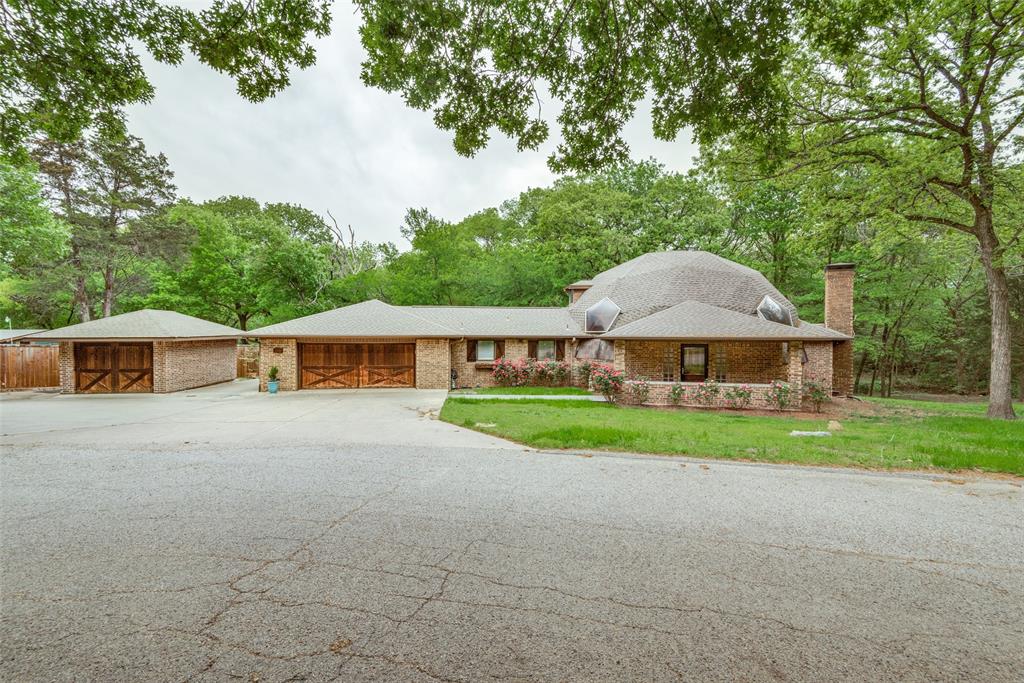 a view of a house with a yard and sitting area