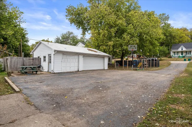 a view of a house with backyard and a tree