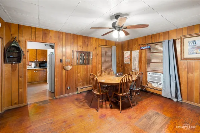 a dining room with furniture window and wooden floor