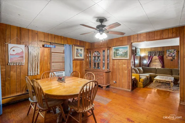 a dining room with furniture window and wooden floor