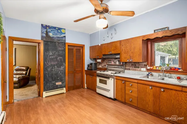 a kitchen with stainless steel appliances granite countertop a stove a sink and a refrigerator