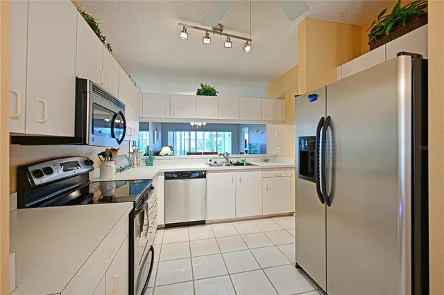a kitchen with cabinets and stainless steel appliances