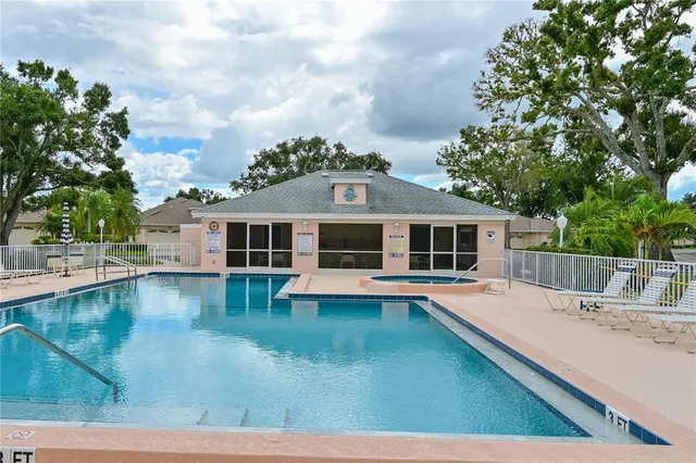 a view of a house with pool and a yard