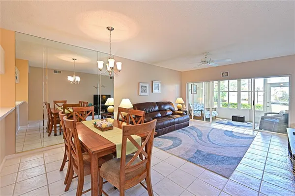 a living room with lots of furniture and a chandelier