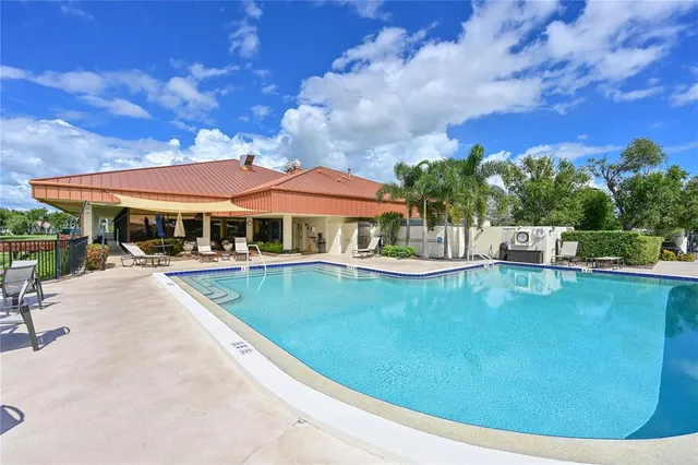 a view of a patio with a dining table and chairs with a small yard