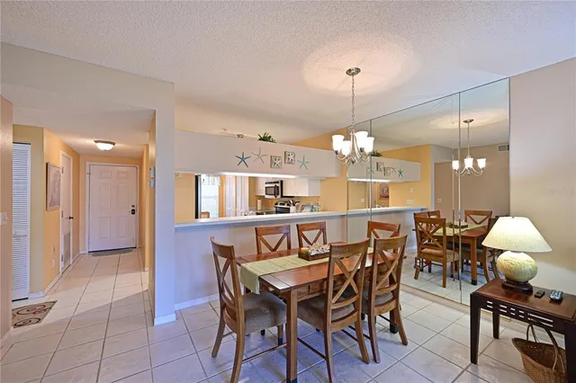 a view of a dining room with furniture and chandelier