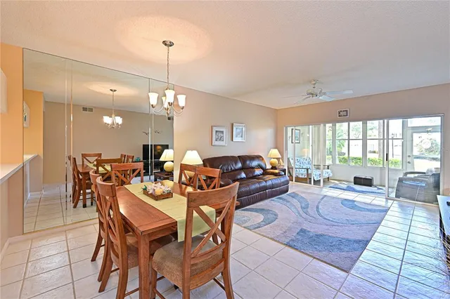 a living room with lots of furniture and a chandelier