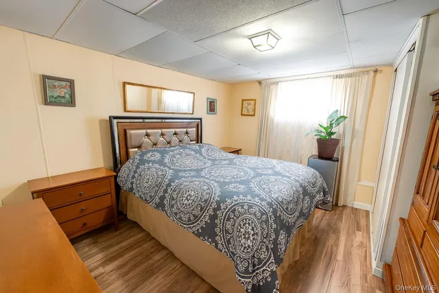 a bed sitting in a bedroom next to a window