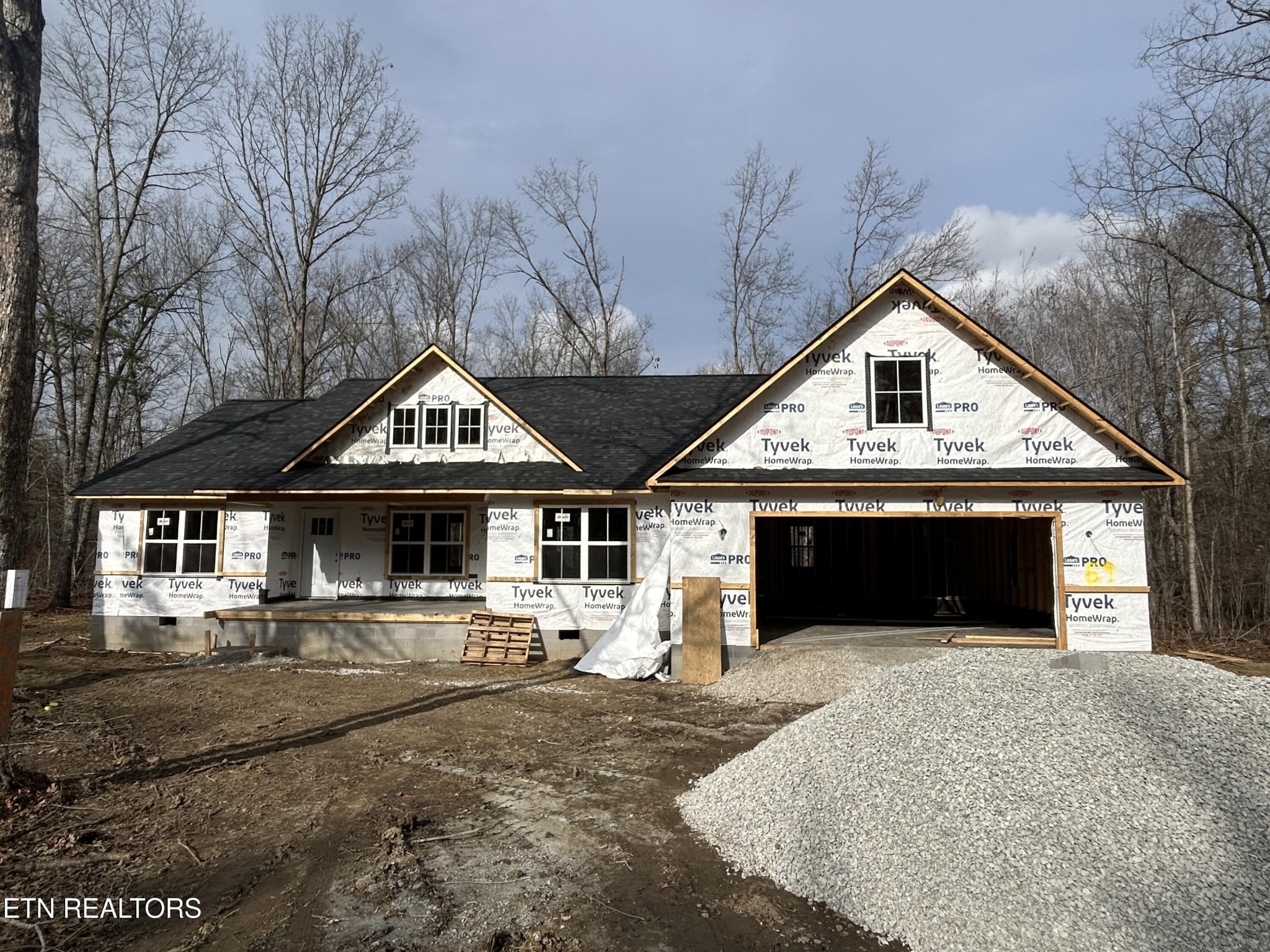 59 C C C Road Monterey, TN 38574 - Photo 2 of 13 a front view of a house with yard and garage