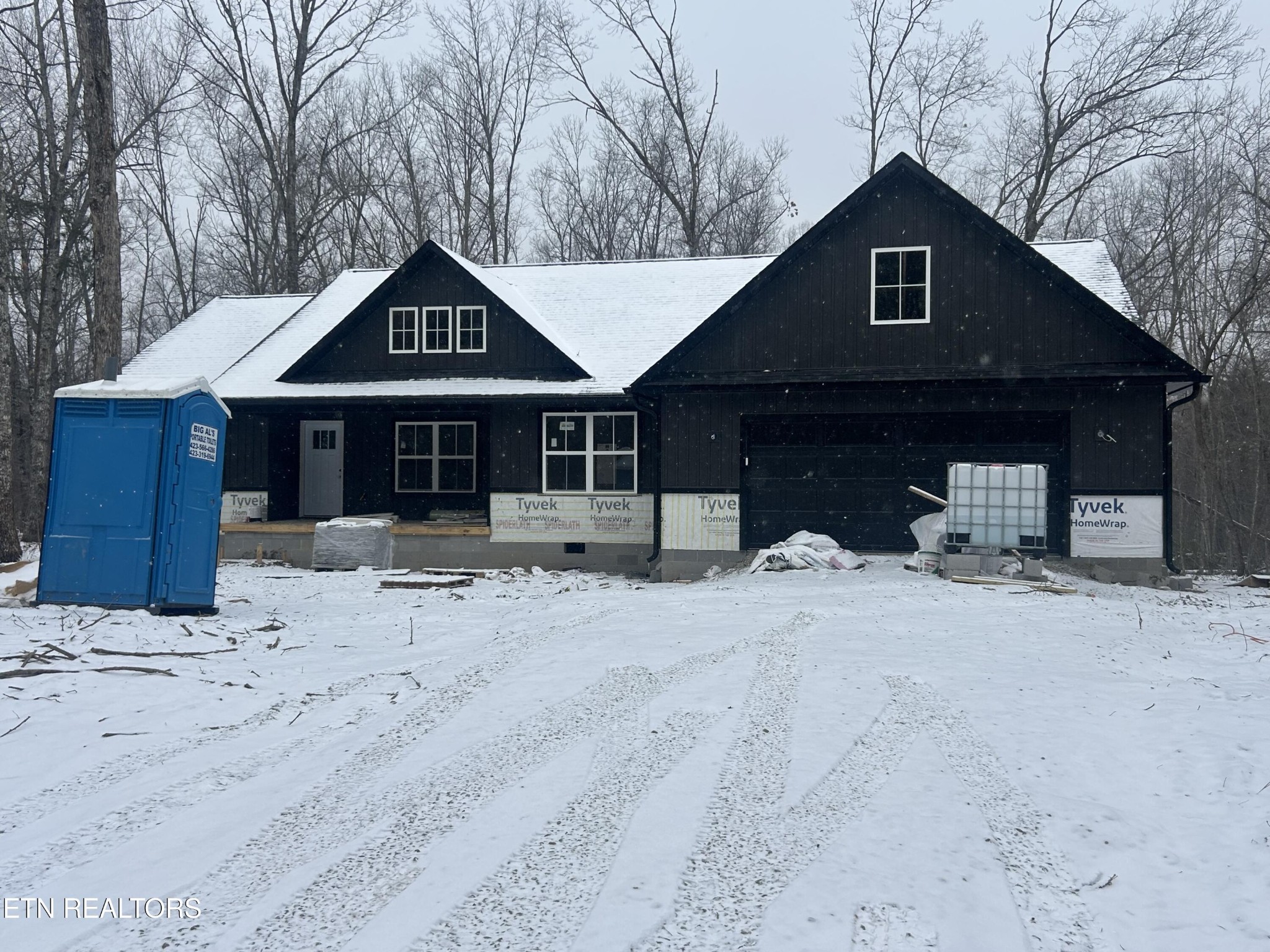 59 C C C Road Monterey, TN 38574 - Photo 3 of 13 a front view of a house with a yard covered in snow