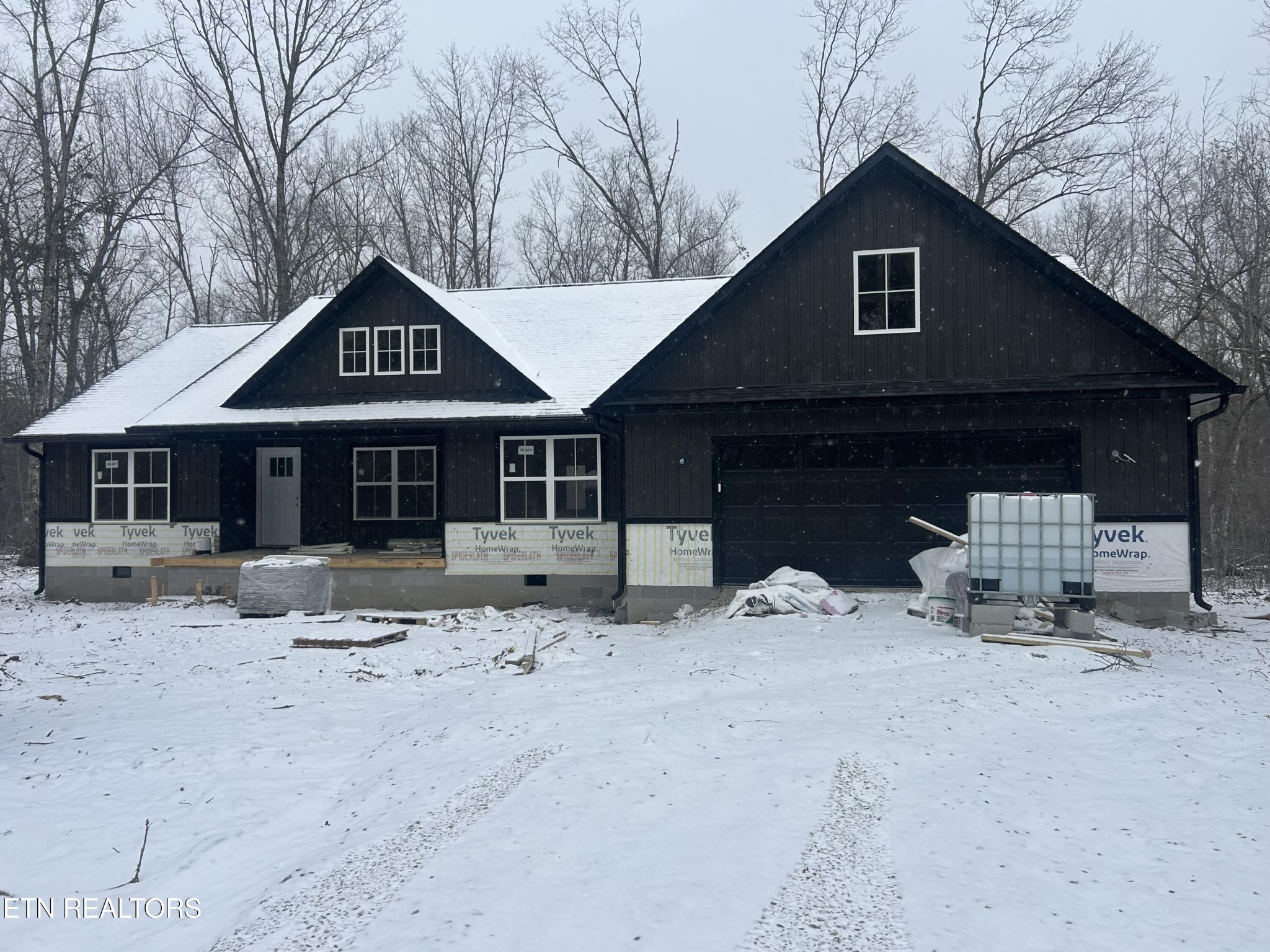 59 C C C Road Monterey, TN 38574 - Photo 4 of 13 a front view of a house with a yard covered in snow
