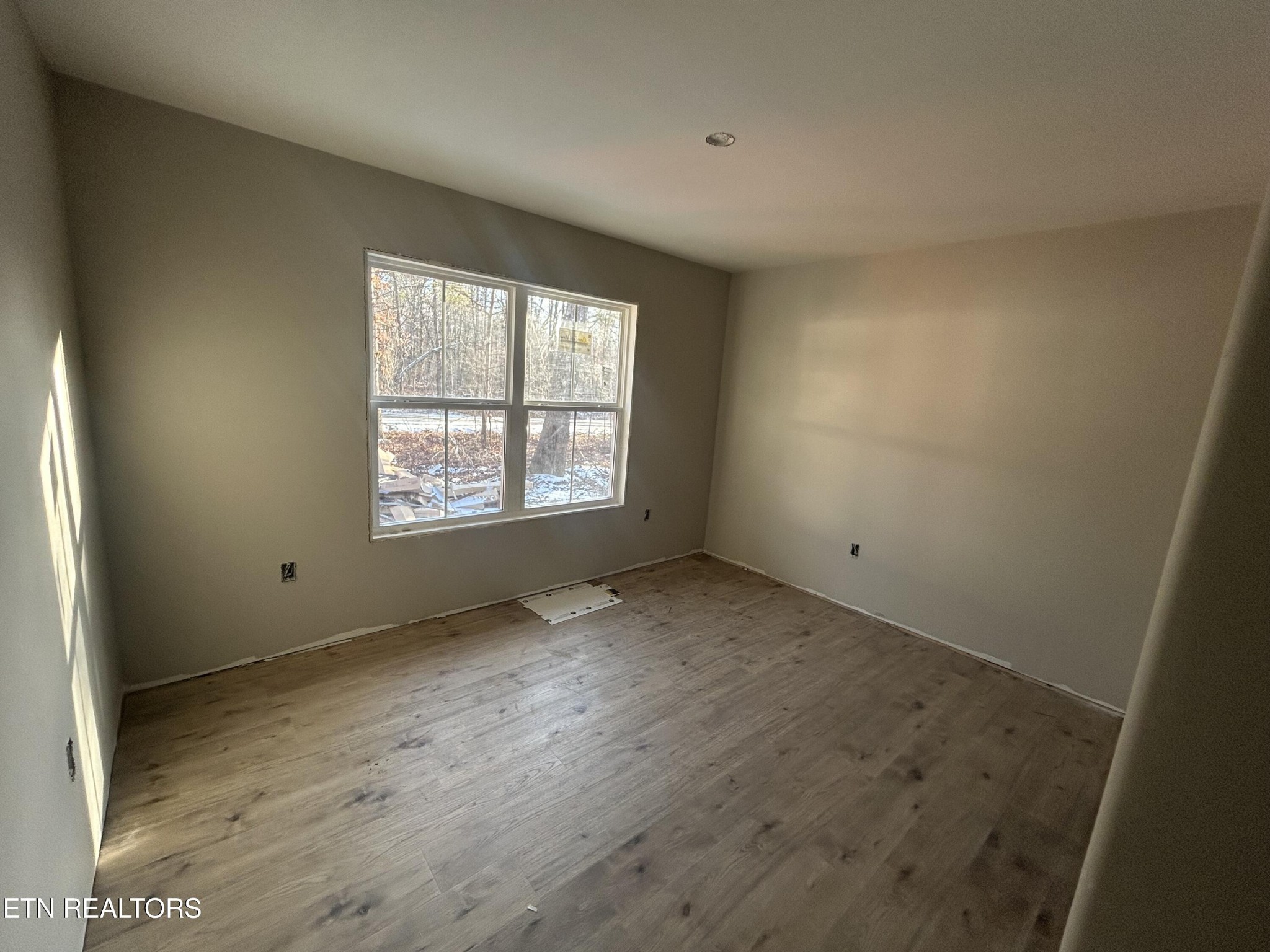 59 C C C Road Monterey, TN 38574 - Photo 8 of 13 an empty room with wooden floor and windows