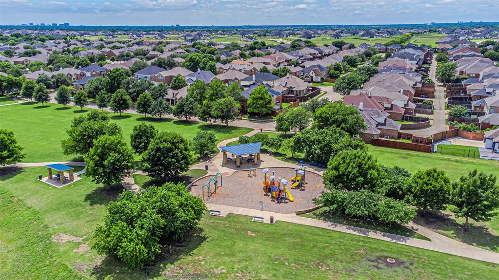 1805 Stetson Way Allen, TX 75002 - Photo 22 of 22 Aerial park and playground featuring multiple slides, swings, and climbing structures, surrounded by mature trees and walking paths