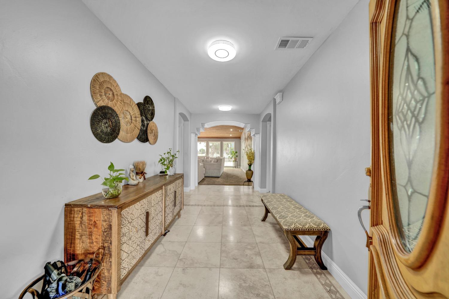 5420 East Jahant Road Galt, CA 95632 - Photo 34 of 73 a hallway with a chandelier