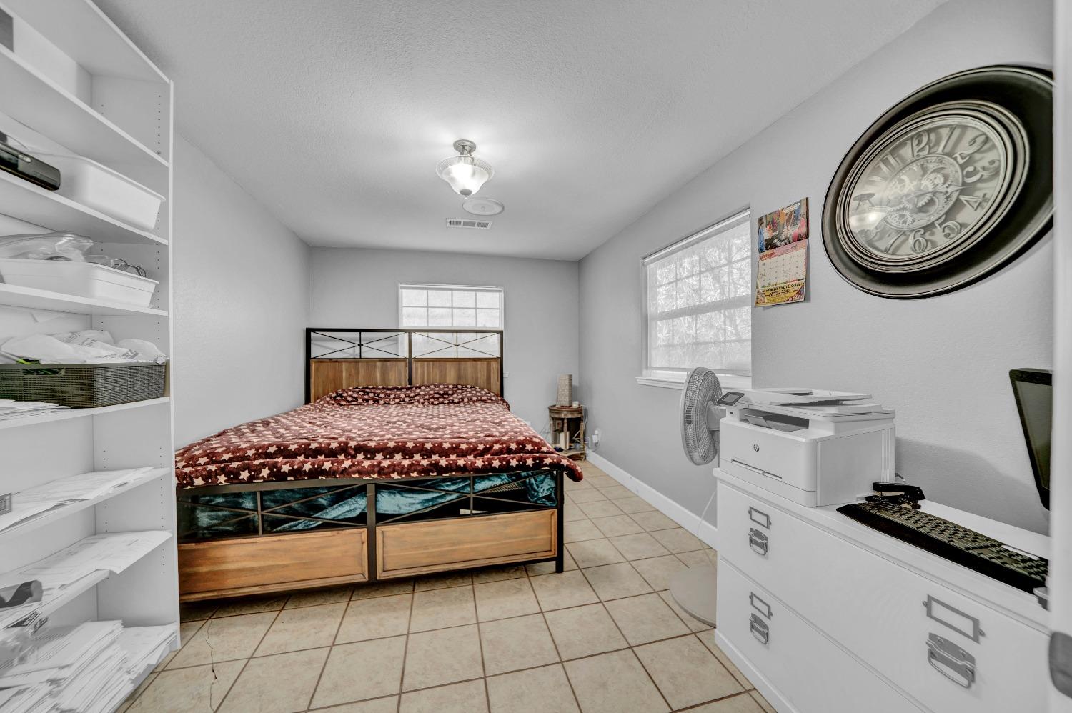 5420 East Jahant Road Galt, CA 95632 - Photo 47 of 73 a bedroom with a bed and a chandelier