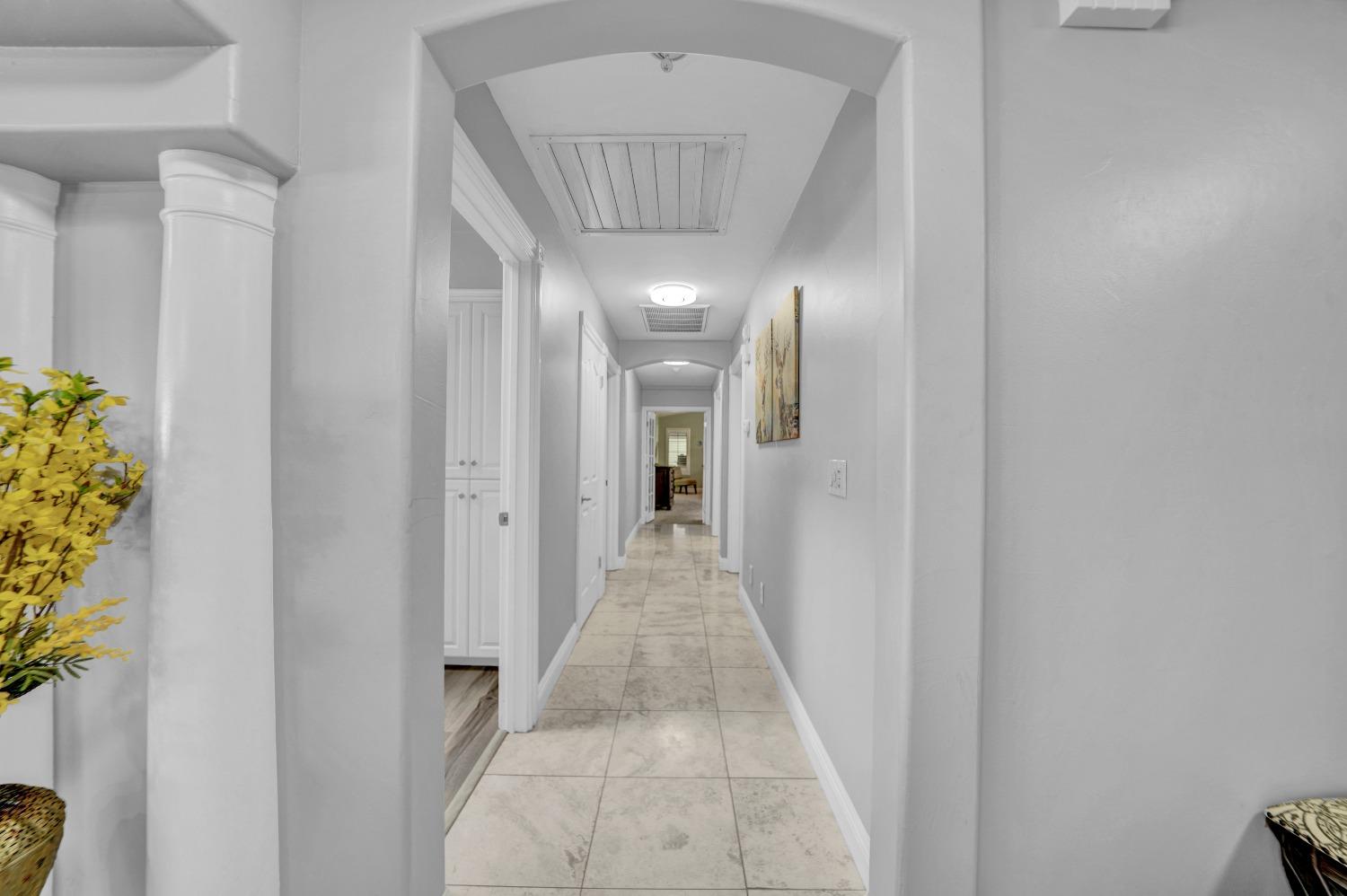 5420 East Jahant Road Galt, CA 95632 - Photo 56 of 73 a view of a hallway with wooden floor and a potted plant