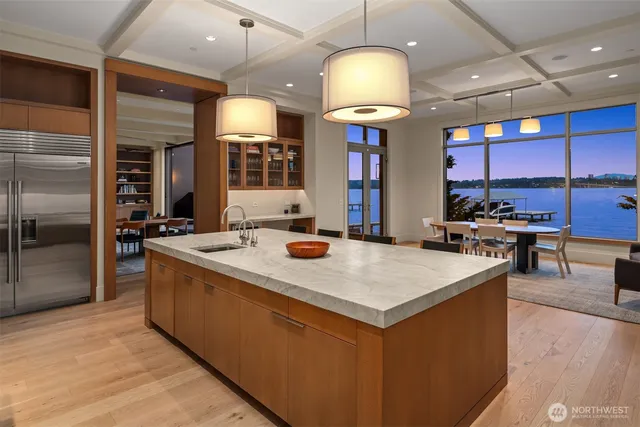 a kitchen with stainless steel appliances a center island and a refrigerator