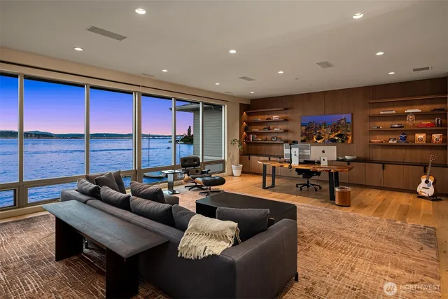a living room with furniture a rug and a large window