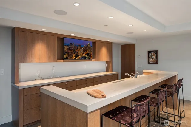 a view of kitchen island with stainless steel appliances cabinets