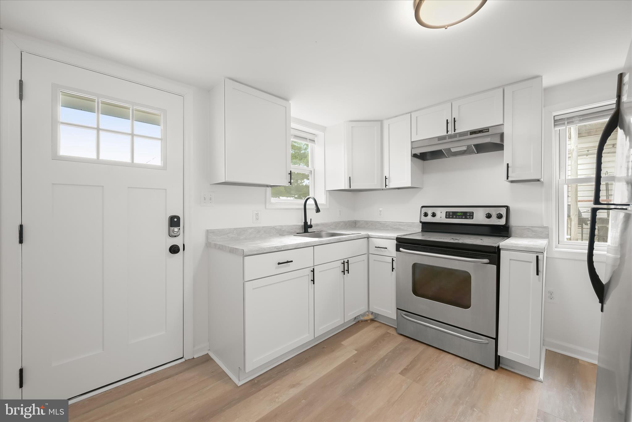 227-229 Main Street New Windsor, MD 21776 - Photo 12 of 36 a kitchen with cabinets appliances and a window