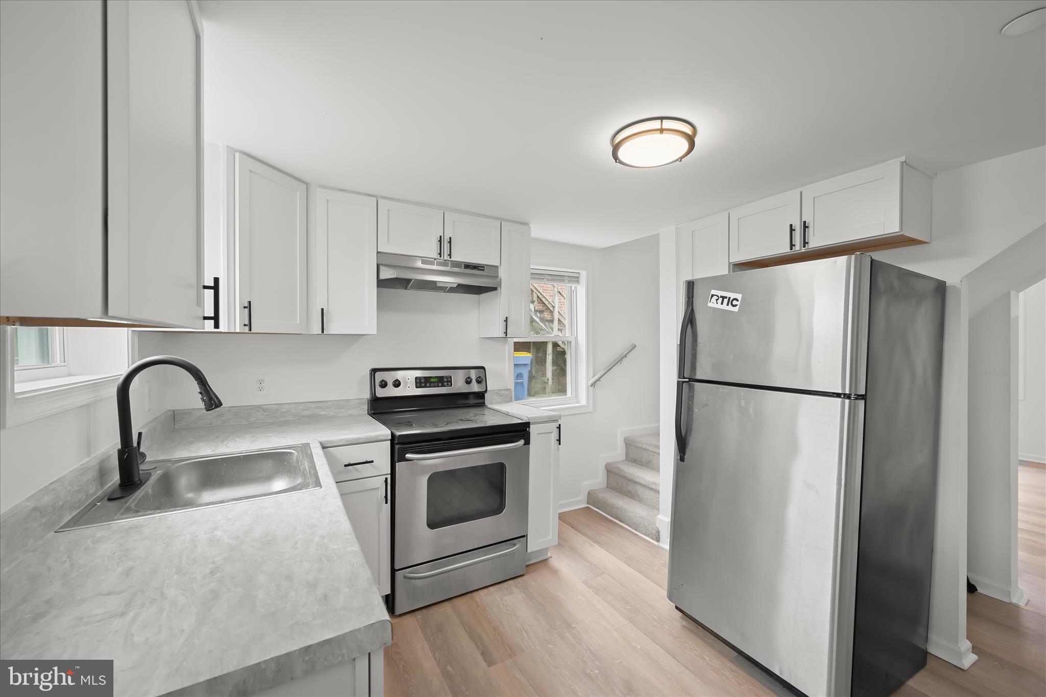 227-229 Main Street New Windsor, MD 21776 - Photo 13 of 36 a kitchen with stainless steel appliances a refrigerator sink and white cabinets