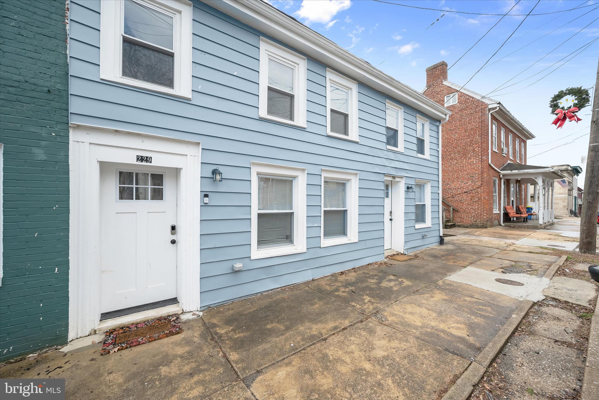 227-229 Main Street New Windsor, MD 21776 - Photo 24 of 36 a front view of a house with a yard