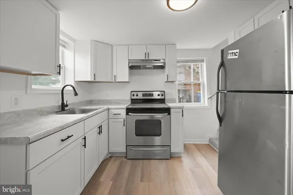 a kitchen with a refrigerator and a stove