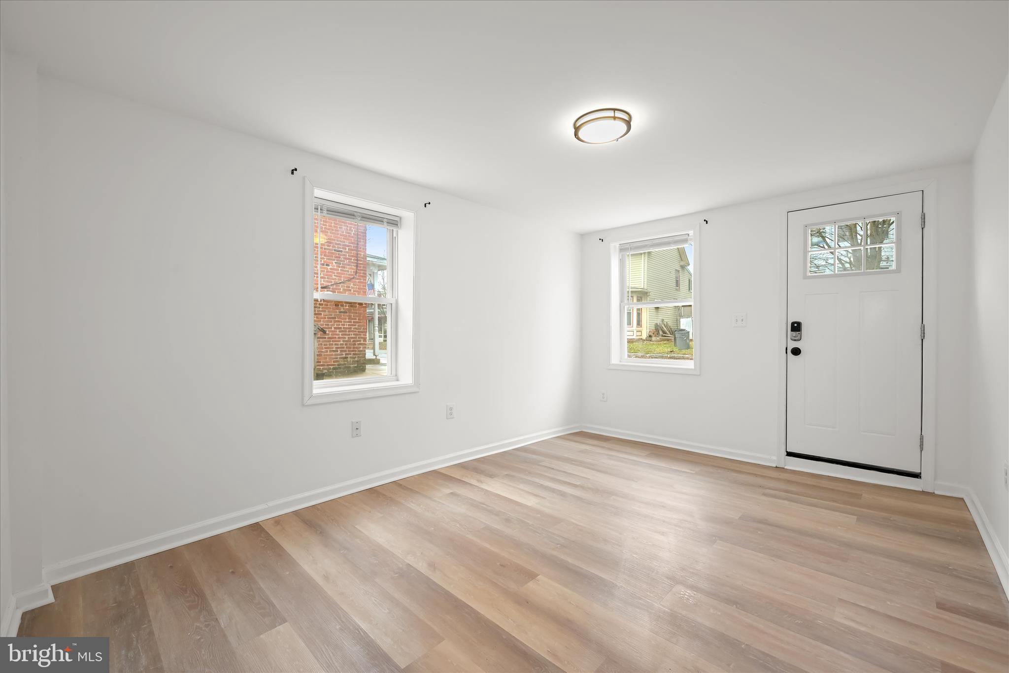 227-229 Main Street New Windsor, MD 21776 - Photo 7 of 36 a view of an empty room with wooden floor and a window
