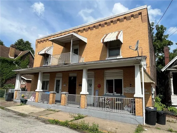 a view of a house with a small yard and a large window