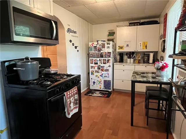 a kitchen with stainless steel appliances granite countertop a stove and a microwave