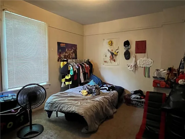 a bedroom with a bed and cabinets