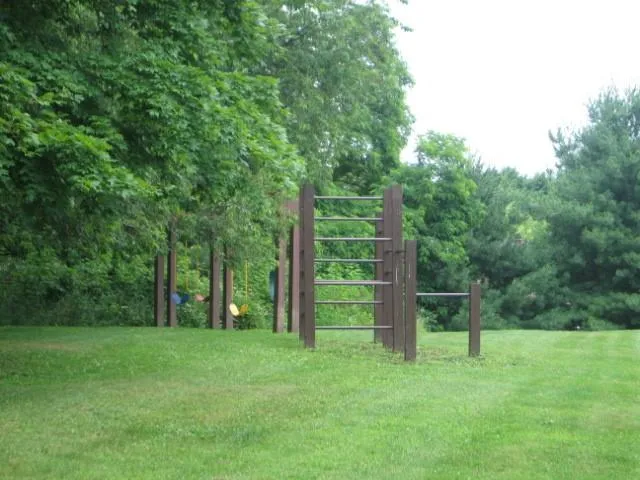 a view of a field with trees in the background