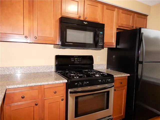 a kitchen with granite countertop cabinets and steel stainless steel appliances