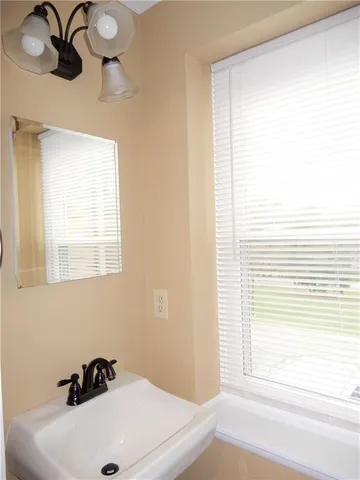 a bathroom with a sink and a window
