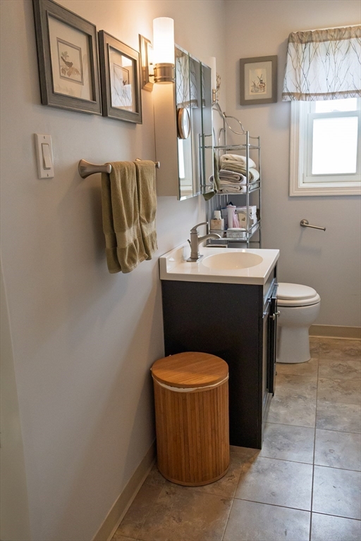 61 Outer Drive, Unit 61 Chicopee, MA 01022 - Photo 15 of 25 a bathroom with a sink toilet and mirror