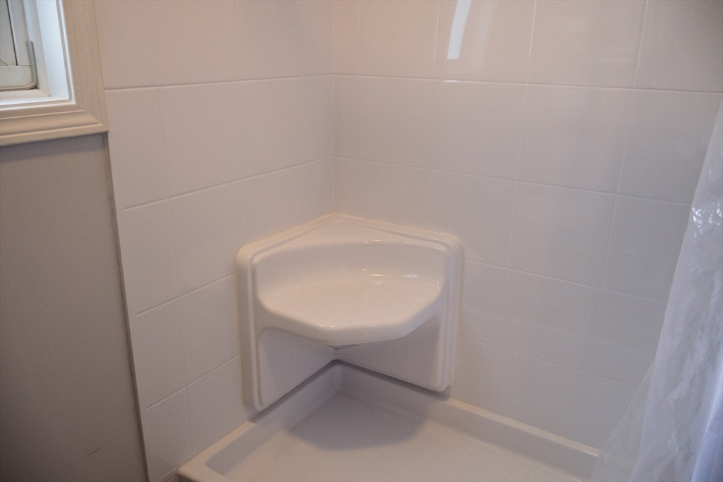 61 Outer Drive, Unit 61 Chicopee, MA 01022 - Photo 17 of 25 a bathroom with a sink and a mirror